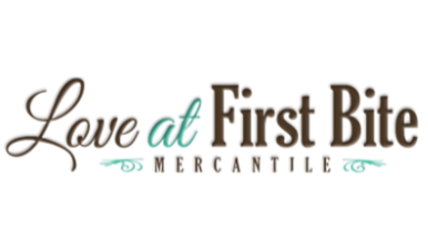 Logo of 'Love at First Bite Mercantile' with decorative elements on a white background
